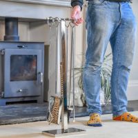 Close up of Polished Stainless Steel Boston Companion Set next to male for scale
