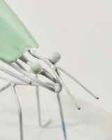 Close up of intricate face detail on recycled metal art sculpture