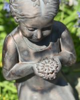 Close up of intricate flower detail on garden statue