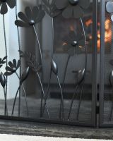 Close up of flower detail on black decorative fire screen Close up of flower detail on black decorative fire screen