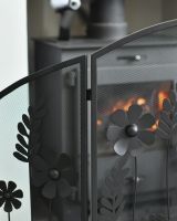 Close up of curved border detail on black decorative fire screen Close up of curved border detail on black decorative fire screen