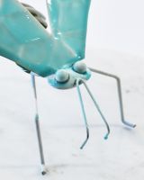 Close up of intricate face detail on colourful home decor ornament Close up of intricate face detail on colourful home decor ornament