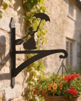 Digital representation of Flying Nanny Iron Hanging Basket Bracket mounted on summer cottage wall