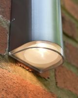 Close up of light detail on garden wall light Close up of light detail on garden wall light