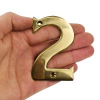Brass number 2 in hand