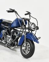 close up of front of industrial blue motorbike art sculpture  close up of front of industrial blue motorbike art sculpture