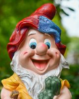 Close up of intricate face detail on colourful garden gnomes