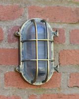 Front view of antique brushed brass garden wall light with ribbed glass detail