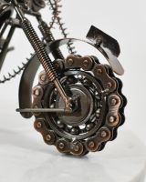 close up of front wheel on recycled metal motorbike sculpture close up of front wheel on recycled metal motorbike sculpture