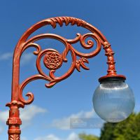 Frosted Glass Globe Luminaire On ornate lamp post bracket