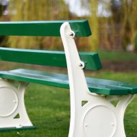 Close up image of back of bench - cream disk & wooden slats Close up image of back of bench - cream disk & wooden slats
