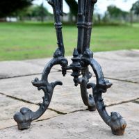Close up of Aged Black Cast Iron Side Table Legs Close up of Aged Black Cast Iron Side Table Legs