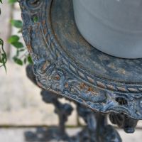Close up of Aged Black Cast Iron Side Table Top Close up of Aged Black Cast Iron Side Table Top
