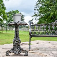 Aged Black Vintage Gothic Side Table in Garden Setting Aged Black Vintage Gothic Side Table in Garden Setting