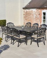 aged_black_moreville_eight_seater_furniture_set_in_situ_outside_on_a_patio with cushions aged_black_moreville_eight_seater_furniture_set_in_situ_outside_on_a_patio with cushions