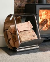 The Bright Chrome Moon Log Holder Positioned next to a Lit Log Burner - Digital Illustration  