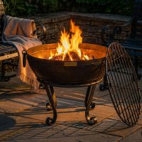 Digital Illustration of the 60cm Version of the Iron Kadai Bowl Fully Lit in Front of Rustic Garden Furniture At Night Digital Illustration of the 60cm Version of the Iron Kadai Bowl Fully Lit in Front of Rustic Garden Furniture At Night