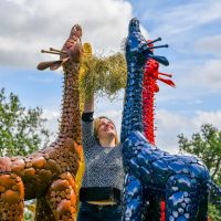 Metal Colourful Giraffe Sculptures with Female for scale Metal Colourful Giraffe Sculptures with Female for scale
