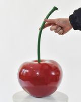 Glace Cherry Cast Aluminium Interior Ornament on a White Background with a Hand in Shot for Scale