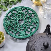 Heavy Duty Cast Iron Round Trivet Being Used on a Dining Room Table