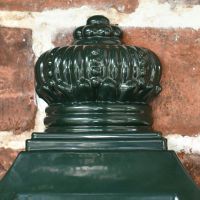 Traditional Finial on the Top of the Green "Odell" Wall Mounted Post Box