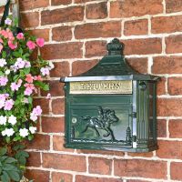 Green "Odell" Wall Mounted Post Box in situ on the Front of a House