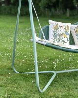 Close up of Green Rattan Swing Seat frame leg