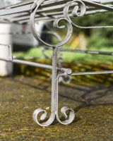 Close up of curved legs on rustic bench 