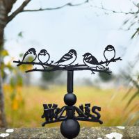 Group of sparrows weathervane in nature