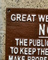 Close up of handpainted detail on cast iron wall sign