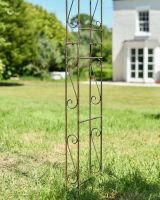 Close up of ornate leg detail on garden rose arch