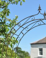 Close up of intricate scrollwork detail on garden arch