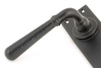 Hammered Aged Bronze Lever Bathroom Door Handle Close-Up Hammered Aged Bronze Lever Bathroom Door Handle Close-Up