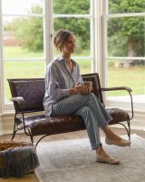 Hand Woven Tan Leather and Iron Two Seater Chair with Person Sat for Scale Hand Woven Tan Leather and Iron Two Seater Chair with Person Sat for Scale