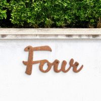 Rustic Handwritten House Number Sign on garden wall