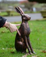 ‘Blossom’ the Cast Aluminium Rabbit Garden Sculpture - Copper scale image with hand to reference