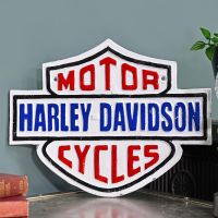 "Harley Davidson" Cycles Cast Automobilia Reproduction Sign in Situ Next to a Blue Wall "Harley Davidson" Cycles Cast Automobilia Reproduction Sign in Situ Next to a Blue Wall