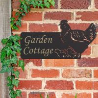 Hen & Chicks Iron House Name Sign in Use on a Brick Wall Hen & Chicks Iron House Name Sign in Use on a Brick Wall