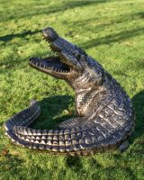 High angle image of black and gold alligator sculpture