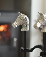 Close up of intricate horse head detail on fireside companion set 