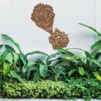 Floating House on Balloons Steel Wall Art in the Garden