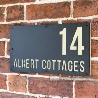Cream "Albert" House Sign in Situ on the Wall Cream "Albert" House Sign in Situ on the Wall