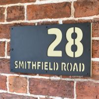 Cream "Smithfield" House Sign in Situ on the Wall Cream "Smithfield" House Sign in Situ on the Wall