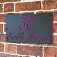 Purple "Saville" House Sign in Situ on the Wall Purple "Saville" House Sign in Situ on the Wall