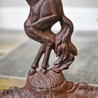 Detailed image of horse tail pattern on casting of umbrella stand