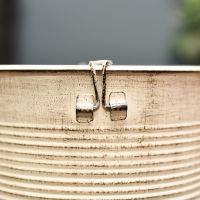 Clasp on fireplace fuel container