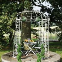 Iron ornate scroll gazebo in garden Iron ornate scroll gazebo in garden