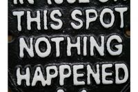 Humorous Emblem Shaped Sign in Black Iron Close-Up Humorous Emblem Shaped Sign in Black Iron Close-Up