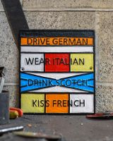 "Drive German, Wear Italian, Drink Scotch, Kiss French" Cast Iron Sign