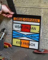 Scale image of "Drive German, Wear Italian, Drink Scotch, Kiss French" Cast Iron Sign